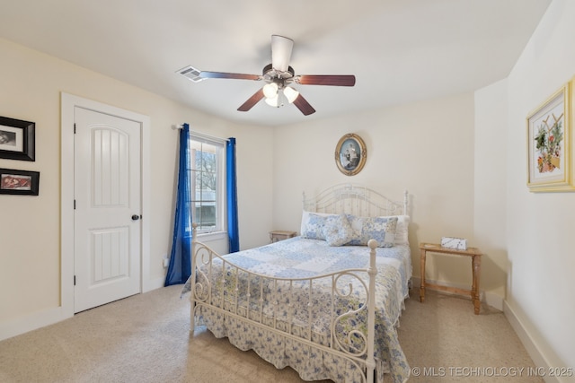 bedroom with light carpet, ceiling fan, visible vents, and baseboards