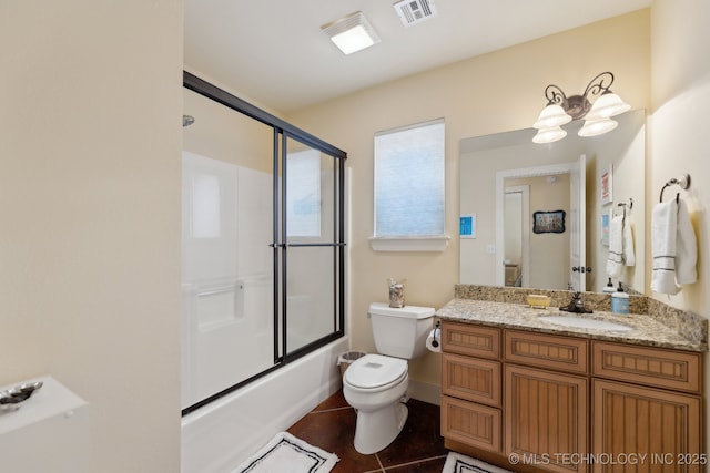 bathroom featuring tile patterned flooring, toilet, shower / bath combination with glass door, vanity, and visible vents