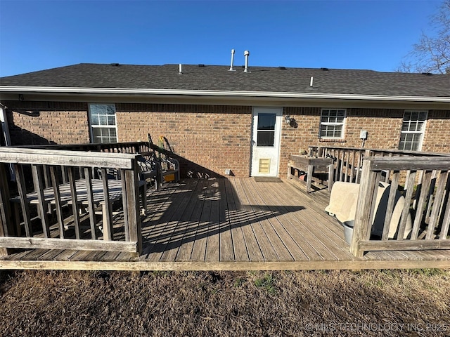 rear view of property featuring a deck