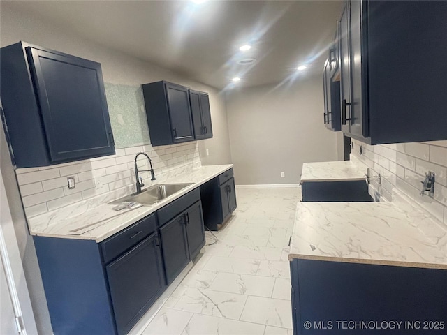 kitchen featuring recessed lighting, baseboards, marble finish floor, and a sink