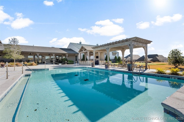 community pool with a pergola and a patio