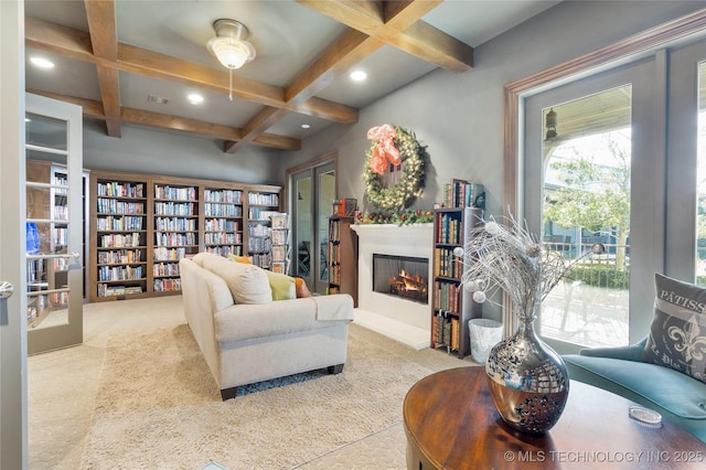 living room with a lit fireplace, recessed lighting, coffered ceiling, and beam ceiling