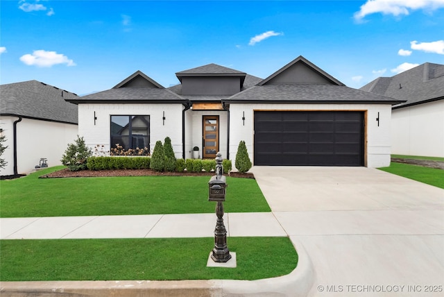 view of front of property with roof with shingles, concrete driveway, an attached garage, and a front lawn