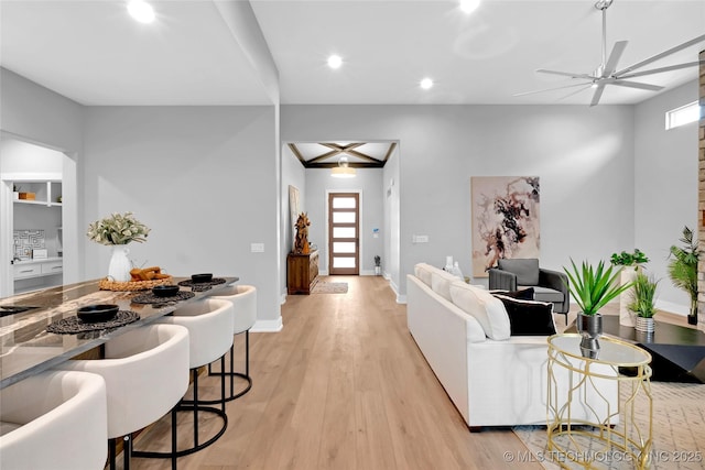 living room with a ceiling fan, baseboards, light wood finished floors, and recessed lighting