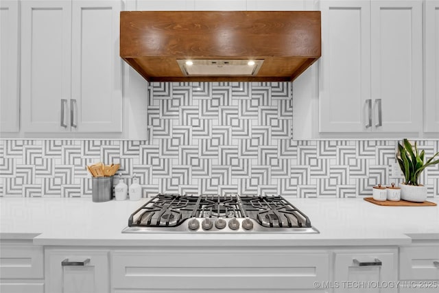 kitchen with white cabinetry, stainless steel gas cooktop, custom exhaust hood, and light countertops