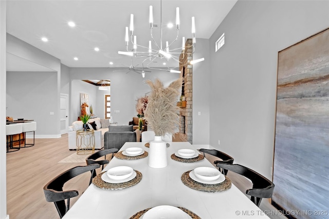 dining room with visible vents, baseboards, wood finished floors, recessed lighting, and a notable chandelier