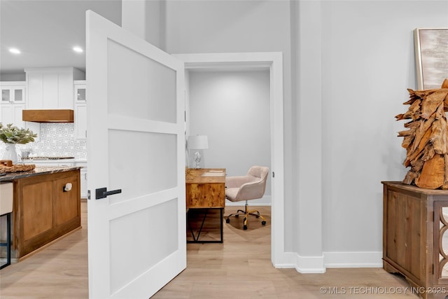 hall with baseboards, recessed lighting, and light wood-style floors