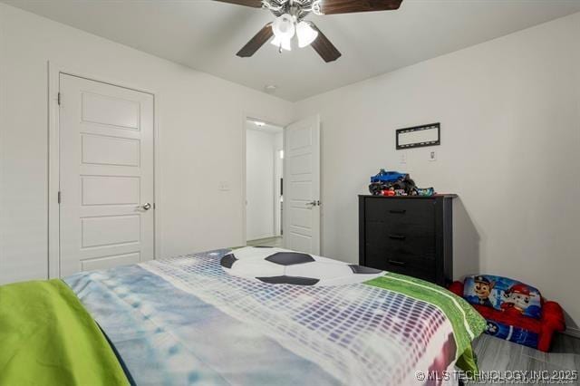 bedroom with wood-type flooring and ceiling fan