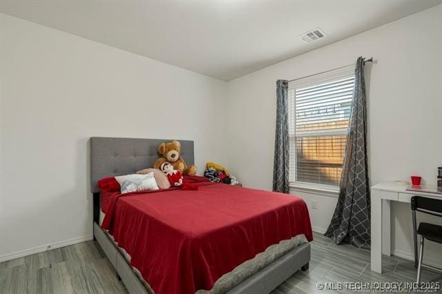 bedroom with light wood-type flooring