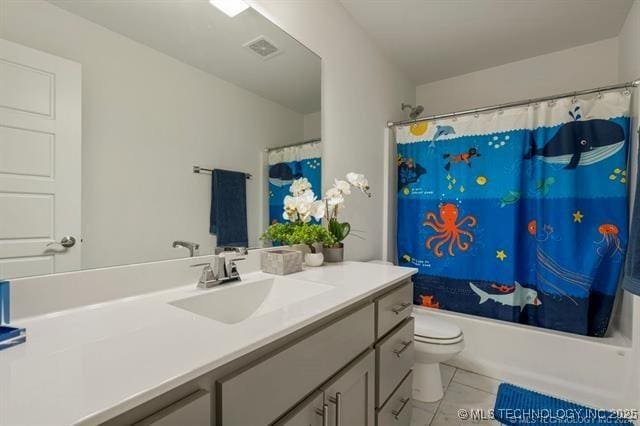 full bathroom featuring tile patterned flooring, vanity, toilet, and shower / tub combo with curtain