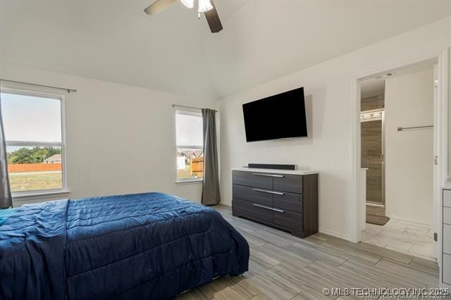 bedroom with ceiling fan and lofted ceiling