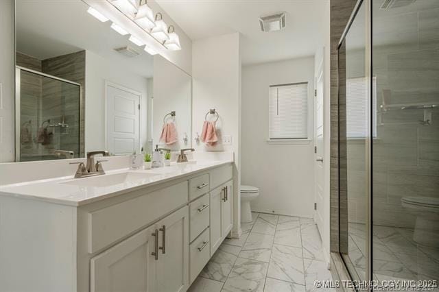 bathroom with vanity, a shower with door, and toilet