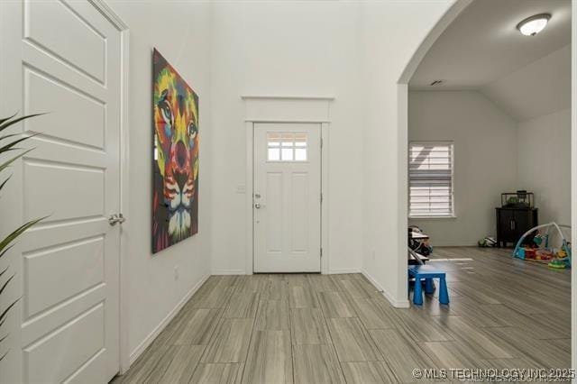 foyer entrance with vaulted ceiling and plenty of natural light