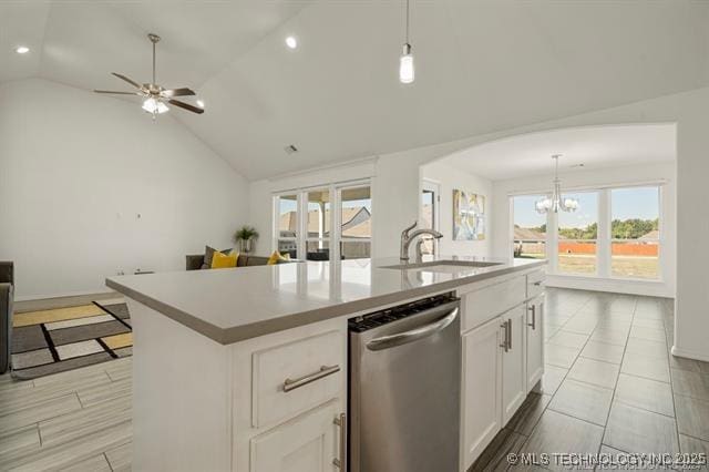 kitchen featuring sink, white cabinetry, stainless steel dishwasher, an island with sink, and pendant lighting