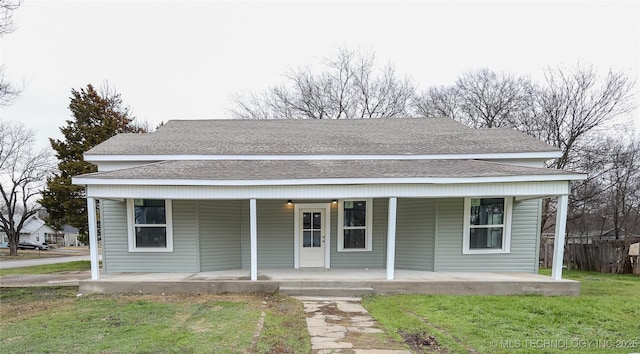 bungalow-style home with covered porch and a front yard