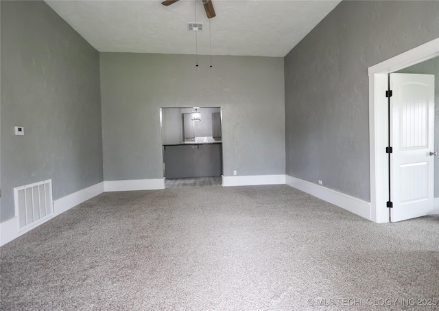 carpeted empty room featuring ceiling fan