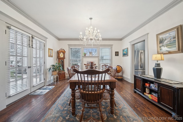 dining area featuring ornamental molding, dark hardwood / wood-style floors, and an inviting chandelier