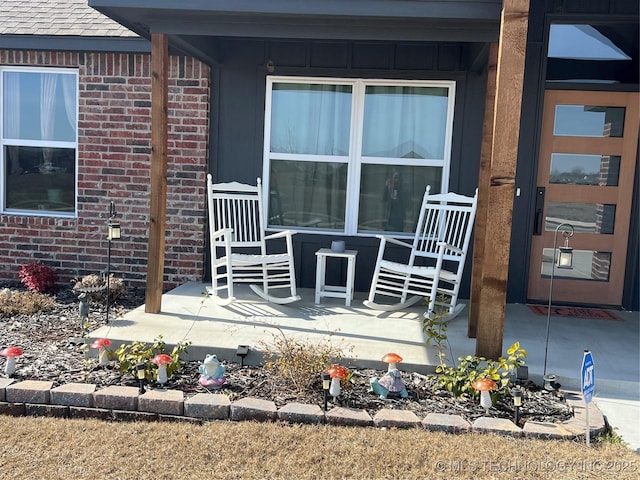 view of exterior entry with covered porch