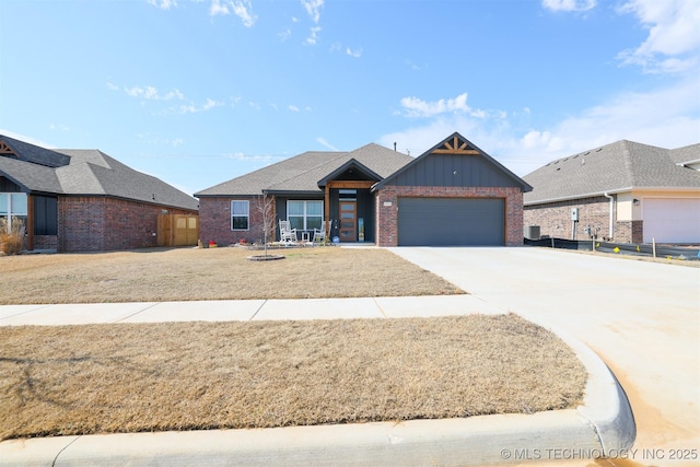 view of front facade featuring brick siding, board and batten siding, a front yard, a garage, and driveway