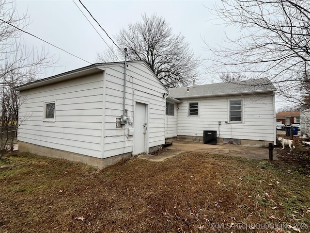 rear view of house featuring central air condition unit and a patio area