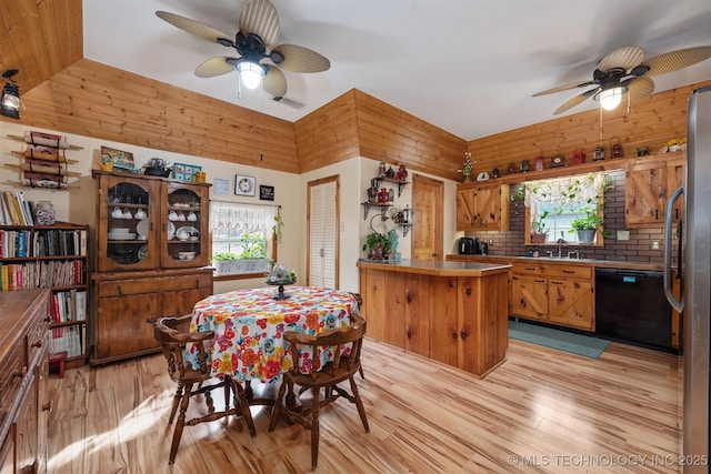 dining space featuring a ceiling fan, vaulted ceiling, visible vents, and light wood-type flooring