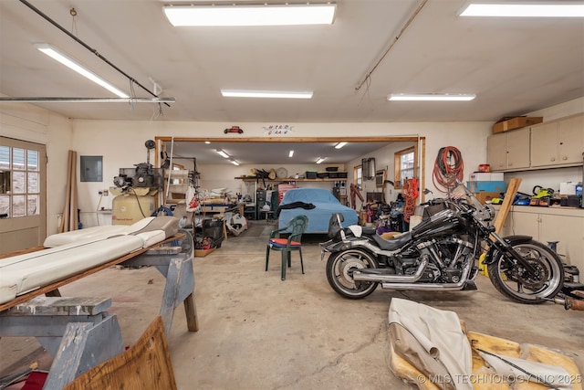 garage with electric panel and a workshop area