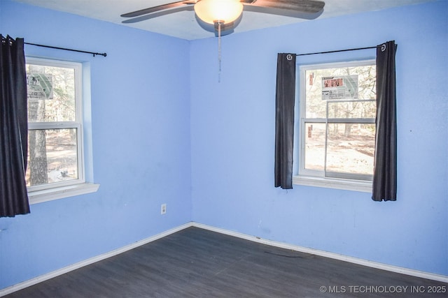 unfurnished room with ceiling fan and dark hardwood / wood-style flooring