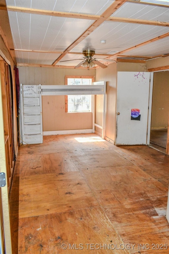interior space with ceiling fan
