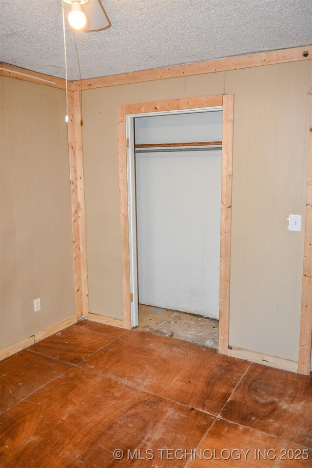 interior space with a closet and a textured ceiling