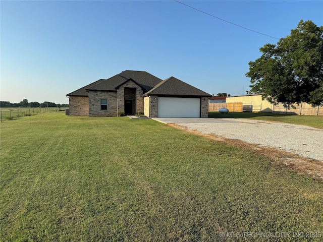 view of front of home with a front lawn and a garage