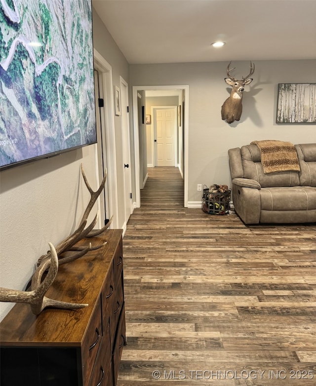 corridor with recessed lighting, dark wood finished floors, and baseboards