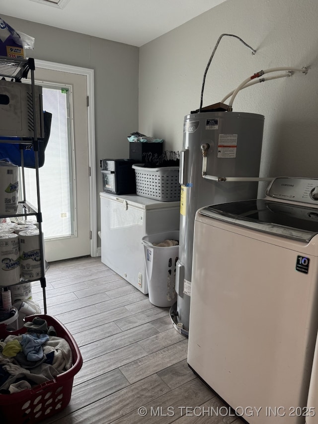 laundry area featuring water heater and washer / clothes dryer