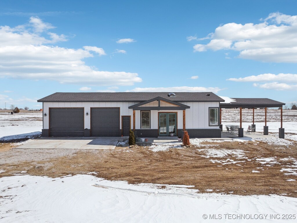 view of front of home with a garage, board and batten siding, and concrete driveway