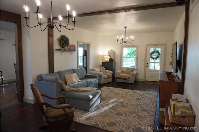 living room with a notable chandelier and dark wood-type flooring