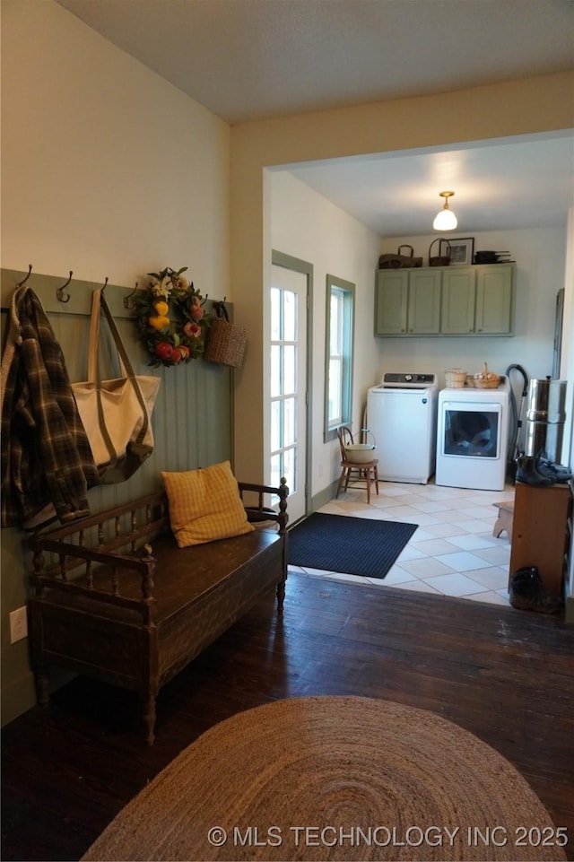 interior space with hardwood / wood-style floors and washing machine and clothes dryer