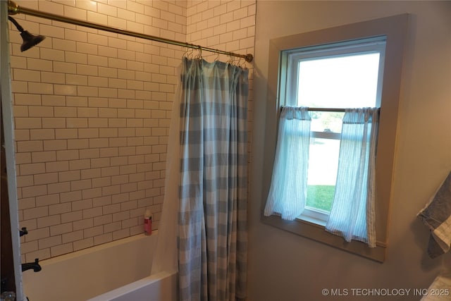 bathroom featuring shower / tub combo with curtain