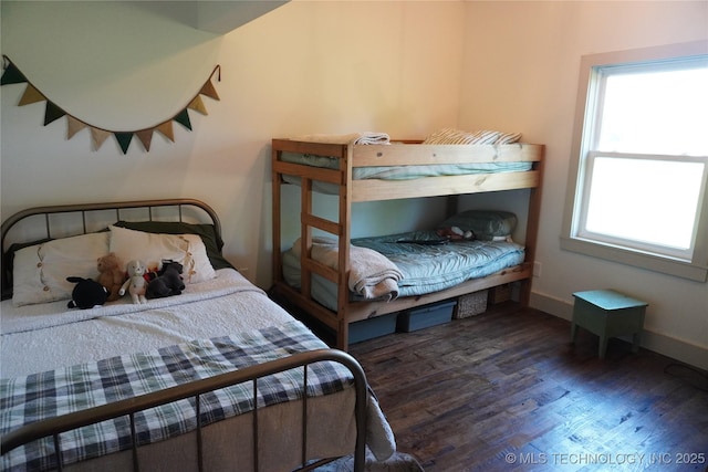 bedroom with dark hardwood / wood-style flooring