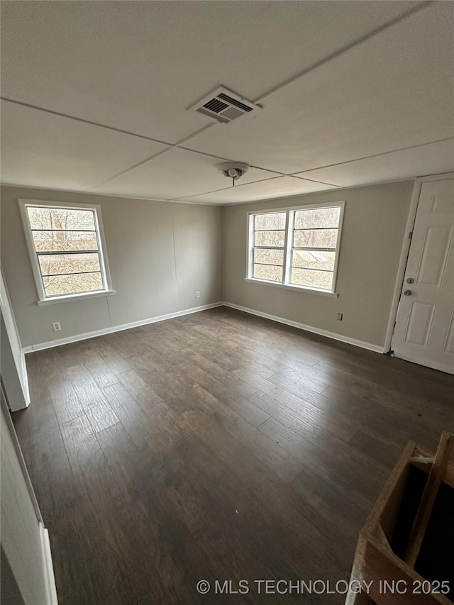 spare room featuring dark wood-type flooring