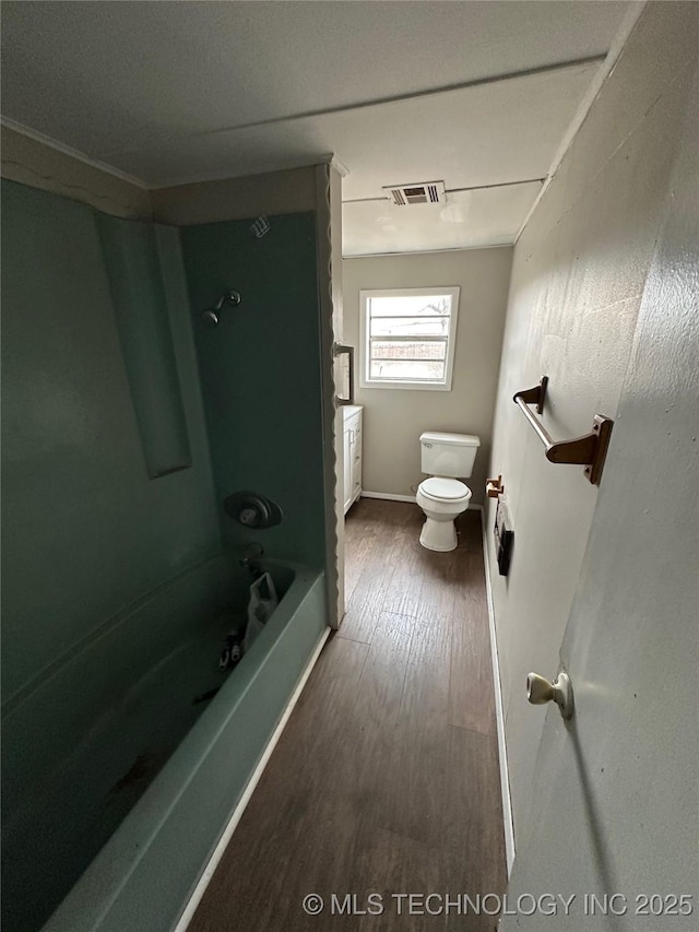 full bathroom featuring hardwood / wood-style flooring, shower / bathtub combination, vanity, and toilet