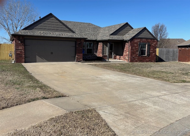 view of front facade featuring brick siding, concrete driveway, an attached garage, and fence