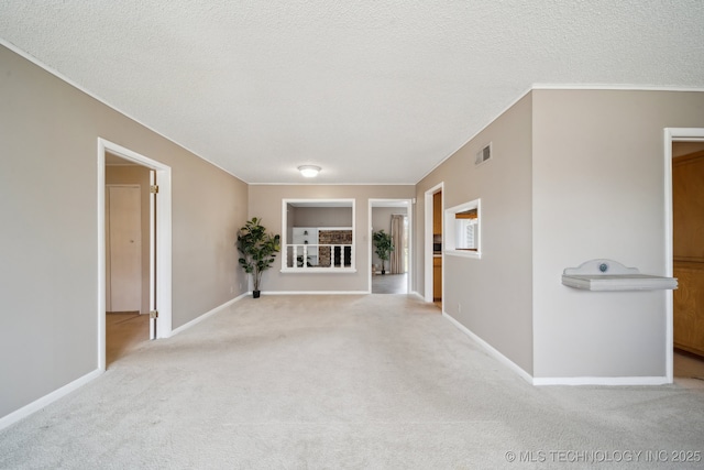 carpeted empty room with a textured ceiling