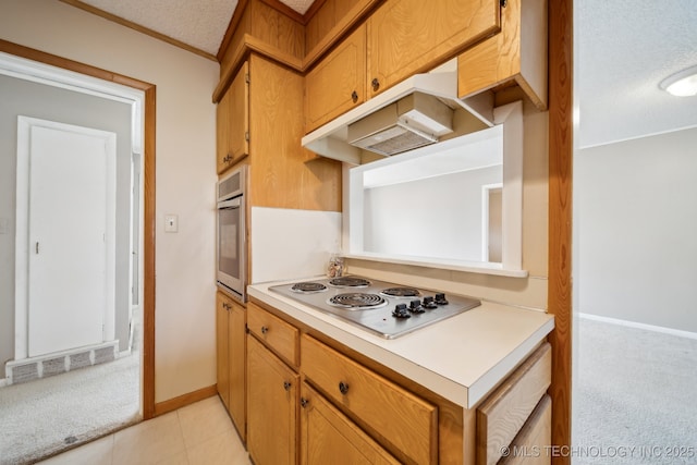 kitchen with white electric stovetop, stainless steel oven, a textured ceiling, and light carpet