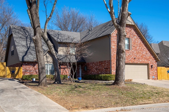 view of front of property with brick siding, roof with shingles, fence, driveway, and a front lawn