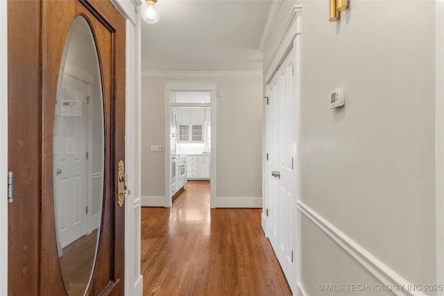 7637 S 26th W Ave, Tulsa, OK 74037 - hallway featuring light wood-style floors, baseboards, and ornamental molding