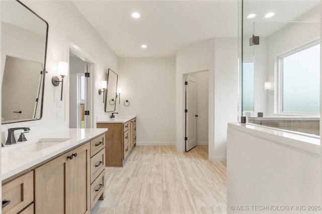 2982 E 145th St S, Bixby, OK 74008 - bathroom with two vanities, baseboards, a sink, and recessed lighting