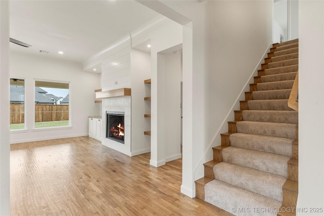 2982 E 145th St S, Bixby, OK 74008 - stairway featuring recessed lighting, a tile fireplace, baseboards, and wood finished floors