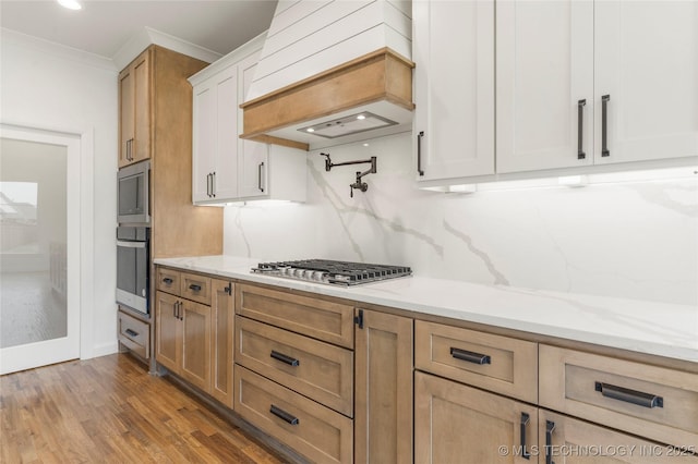 2982 E 145th St S, Bixby, OK 74008 - kitchen with light stone counters, tasteful backsplash, stainless steel appliances, custom range hood, and ornamental molding
