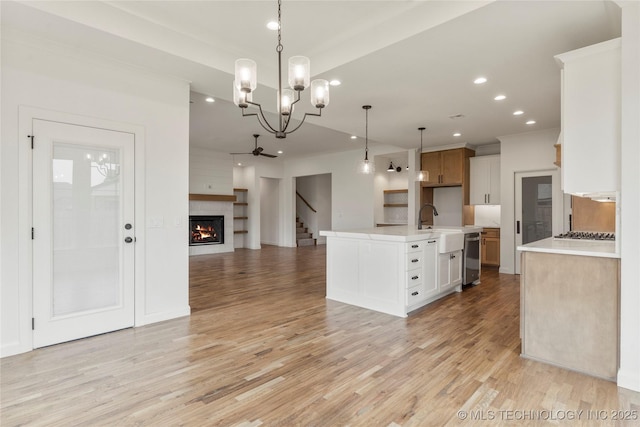 2982 E 145th St S, Bixby, OK 74008 - kitchen with a warm lit fireplace, open floor plan, light wood finished floors, light countertops, and recessed lighting