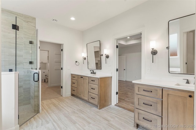2982 E 145th St S, Bixby, OK 74008 - full bathroom featuring recessed lighting, two vanities, a shower stall, and a sink