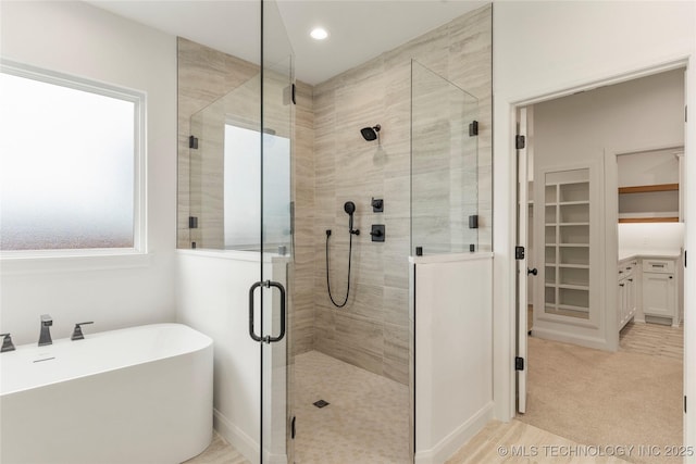 2982 E 145th St S, Bixby, OK 74008 - bathroom with recessed lighting, a soaking tub, and a stall shower